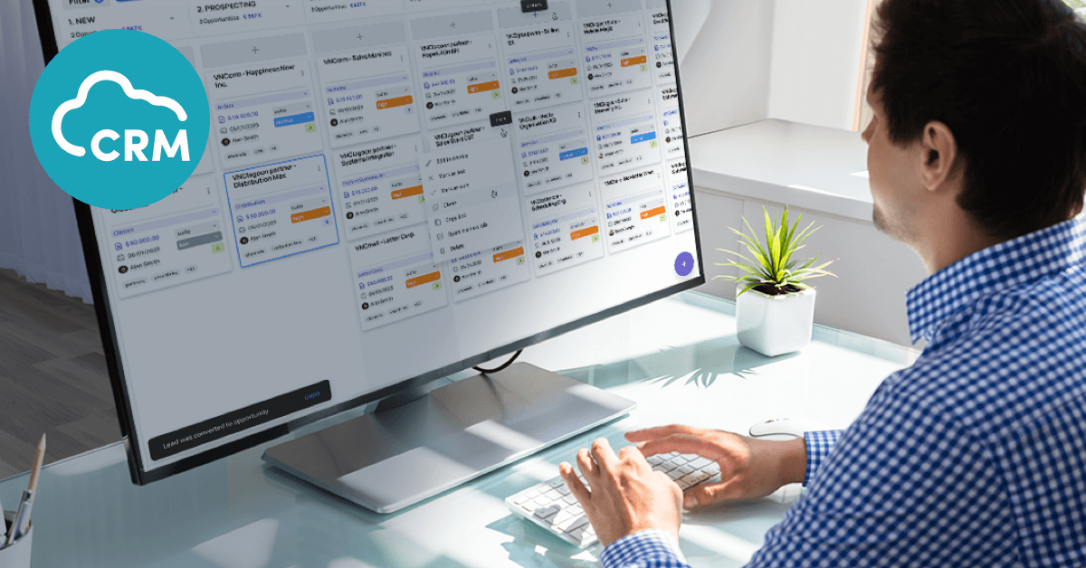 Young man sitting in front of a screen, hands on the keyboard, looking at the VNCcrm Dashboard